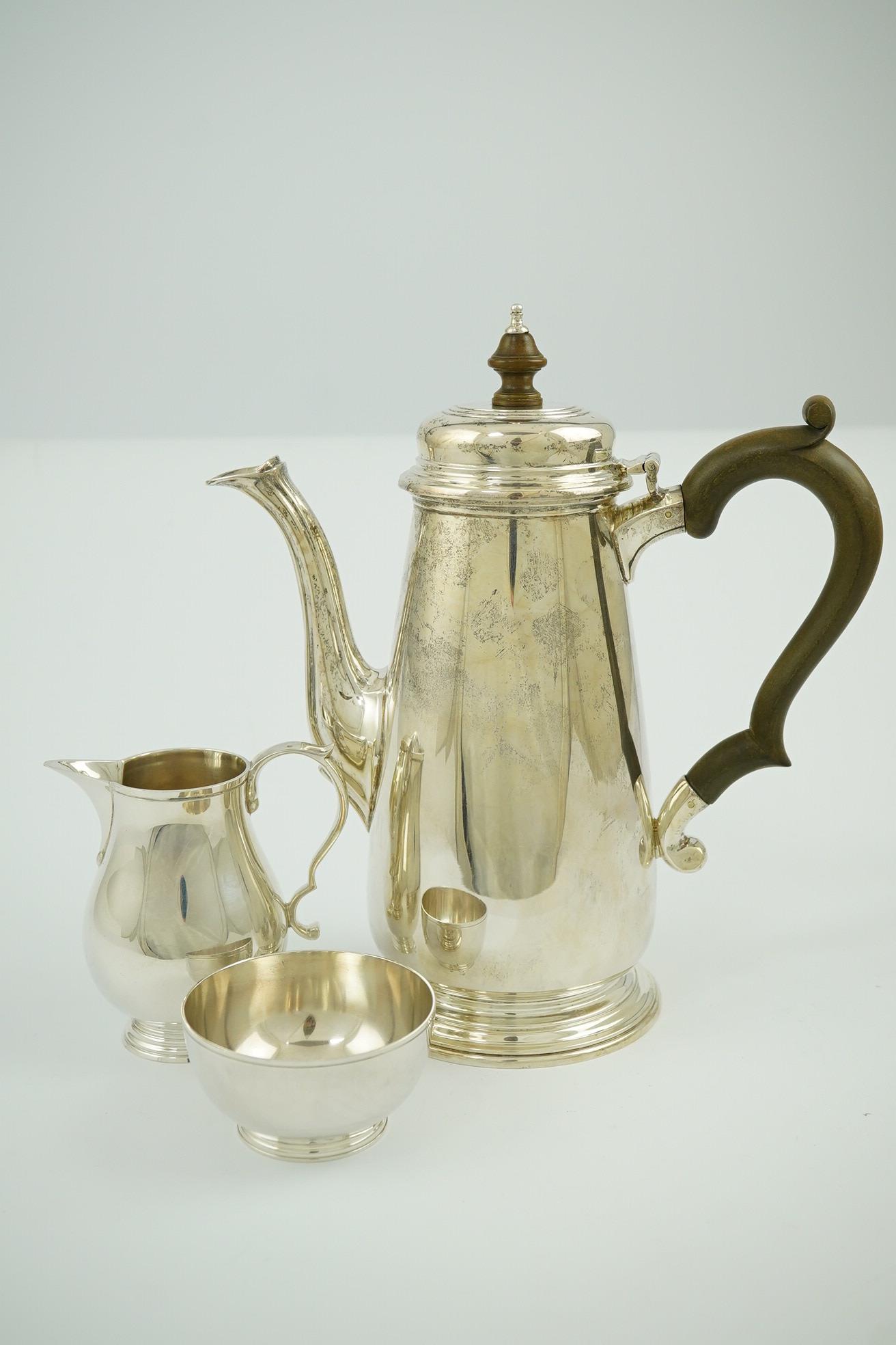 An Elizabeth II matched silver three piece coffee set by William Comyns & Sons Ltd